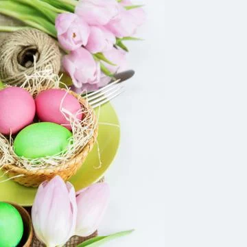 Basket with Easter eggs  and flowers Stock Photos