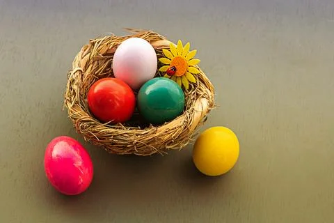 Basket of easter eggs with flower close up on gray background Stock Photos