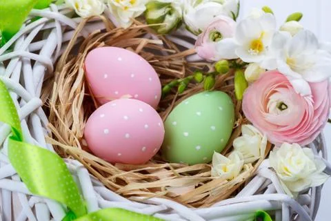 Basket of easter eggs with flowers Stock Photos