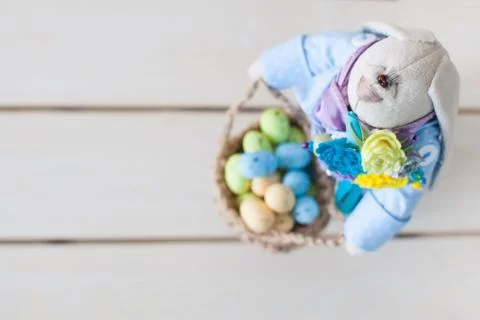 Basket with Easter eggs. Nest for eggs. Rabbit is a handmade toy. Stock Photos