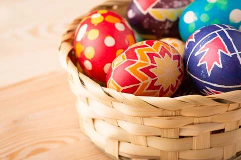 Basket of Easter eggs on wooden table Stock Photos