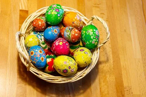 Basket with Easter eggs on wooden table Stock Photos