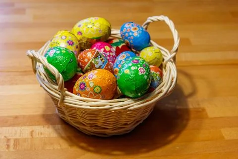 Basket with Easter eggs on wooden table 写真素材