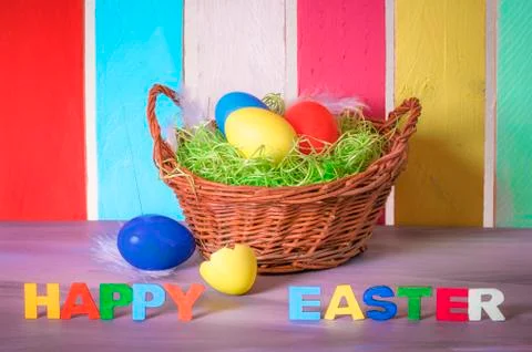 Basket with eggs and happy easter words Stock Photos