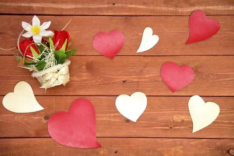 A basket of flowers. paper elements in the shape of a heart, on a wooden Foto stock