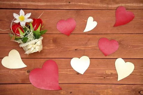 A basket of flowers. paper elements in the shape of a heart, on a wooden Stock Photos