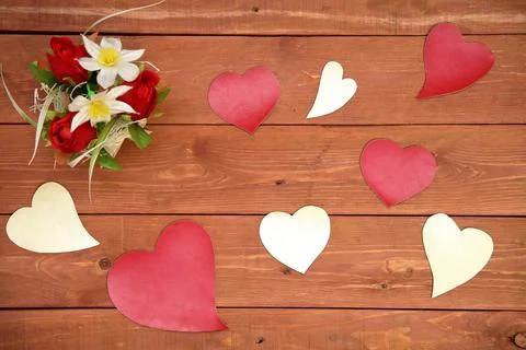 A basket of flowers. paper elements in the shape of a heart, on a wooden Stock Photos
