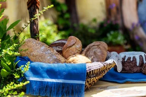 Basket with fresh bread on the table outside the house Stock Photos