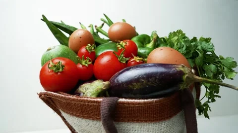 Basket of Fresh Vegetables and Eggs, A basket filled with fresh vegetables .. 스톡 동영상 305045603