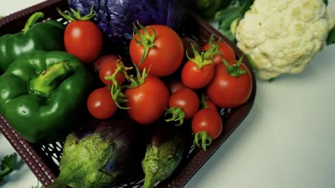 Basket of Fresh Vegetables on White Surface, A basket filled with fresh veg.. Stock Footage 305029898