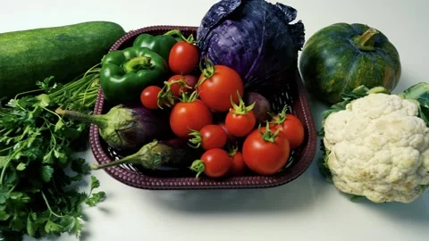 Basket of Fresh Vegetables on White Surface, A basket filled with fresh veg.. Vídeos de archivo 305030151