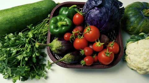 Basket of Fresh Vegetables on White Surface, A basket filled with fresh veg.. Video stock 305030205