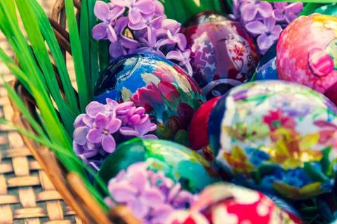Basket full of Easter decoration standing on stripped table Stock Photos