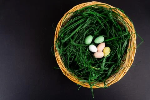 A basket full of grass and easter colorful easter eggs with copy space Stock Photos