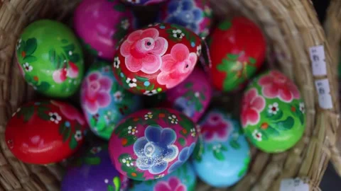 A basket full of hand-painted Easter eggs bursts with color and charm—each egg a Stock Footage 306677305