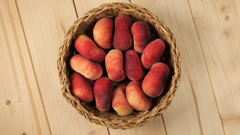 Basket full of ripe peaches rotating Stock Footage 338312325