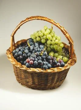 Basket with grapes Stock Photos