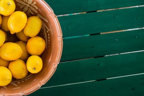 Basket of lemons on the coloful table with copyspace Stock Photos
