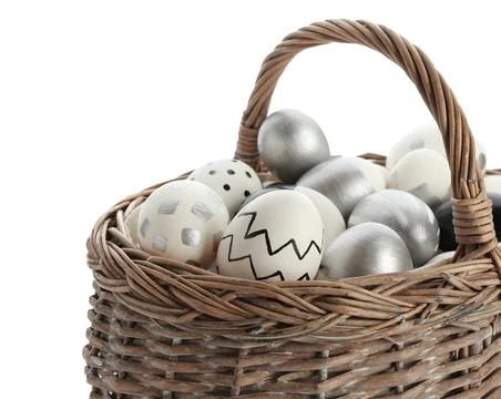 Basket with painted Easter eggs on white background, space for text Stock Photos