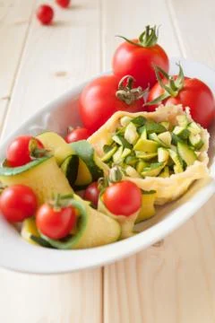 Basket of parmesan with veggies Stock Photos