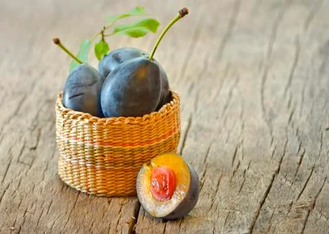Basket with plums Stock Photos