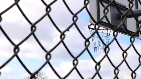 Basket Ring view focused through metal grey fence foreground Stock Footage 98573569