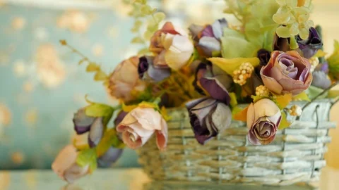 Basket rose artificial flowers on table Stock Footage 92092882