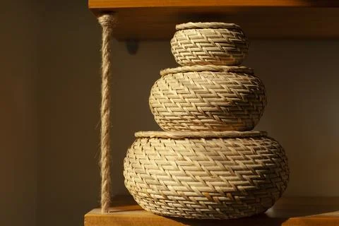 Basket for small things. Object in interior. Braided box is rounded in shape. Stock Photos