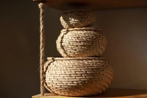 Basket for small things. Object in interior. Braided box is rounded in shape. Stock Photos