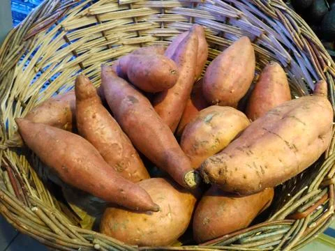 Basket of sweet potatoes Stock Photos