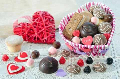 , Basket with sweets and biscuits on the table, decorative Valentine day heart 스톡 사진