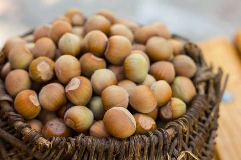 A basket of toasted hazelnuts inviting Foto stock