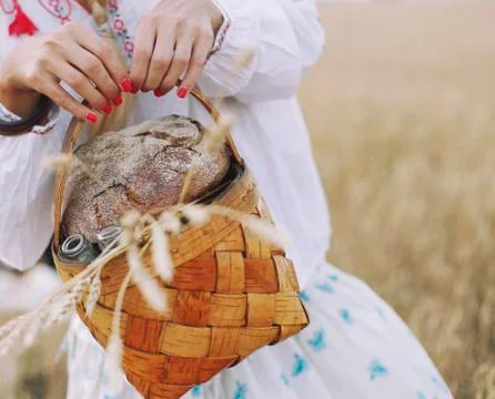 Basket in the women's hands with bread Stock Photos