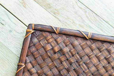 Basket work mat pattern on wooden floor Stock Photos