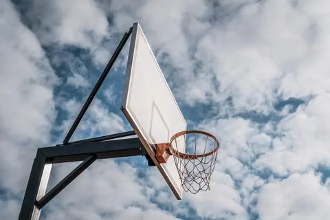 Basketball Backboard and Hoop in front of sky background Stock Photos