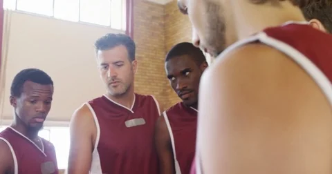 Basketball coach assisting players Stock Footage