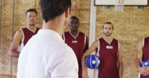 Basketball coach interacting with players Stock Footage