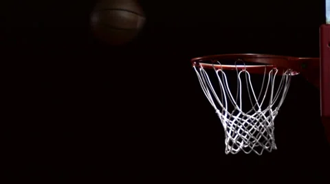 A basketball floats through the air and hits the rim and bounces away Stock Footage