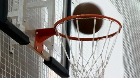 The basketball game ball successfully makes it through the hoop Stock Footage 239363090