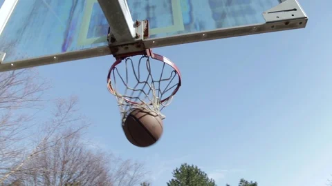 Basketball going into hoop Stock Footage 94885199
