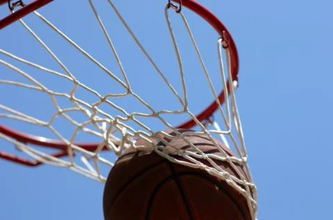 Basketball going through net Stock Photos