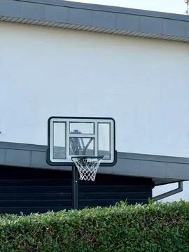 Basketball hoop in a backyard setting Stock Photos