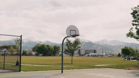 Basketball Hoop With Mountain Range Background in Public Park Tracking Shot Vidéo 336794905