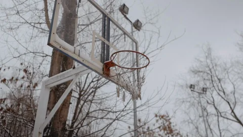 Basketball hoop in winter Stock Footage 129681197