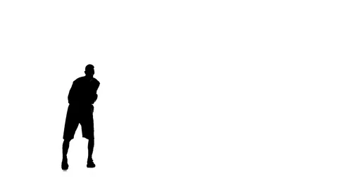 Basketball makes a feint, and stuffing the ball. Silhouette. White background Stock Footage 70506570