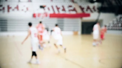 Basketball match scene with players unfocused in the background Stock Footage