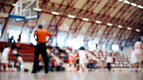 Basketball match scene with players unfocused in the background Stock Footage
