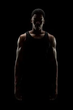 Basketball player against black background. Serious concentrated african amer Stock Photos