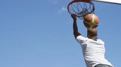 Basketball player does a reverse slam dunk, in slow motion Stock Footage 67367999