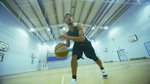 Basketball player dribbling the ball down the court Free Stock Footage 46202253